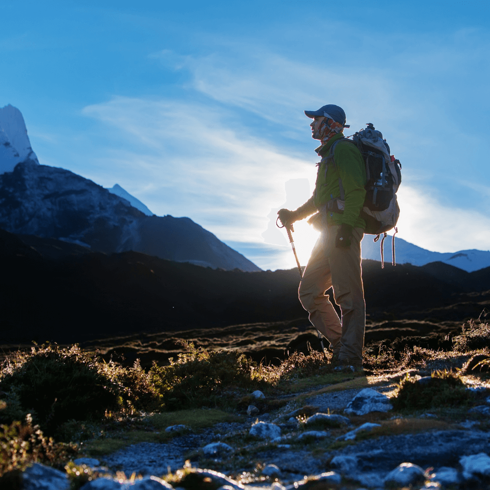 hiker with a backpack trekking through scenic mountains during sunset, ready for adventure travel. Adventure Travel Gear Collection